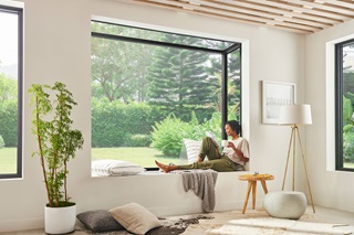 A woman sitting in Marvin Skycove with a view of the outdoors.