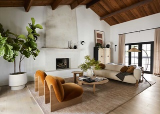 A modern living room in the Bobby Berk Firm’s office, featuring Marvin Ultimate Inswing French doors and modern furnishings.