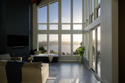 A living room in California featuring large Marvin Ultimate windows overlooking a bay view.