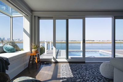 Marvin Skycove and a Marvin Modern Multi-Slide door in a living room overlooking the Logan airport runways.