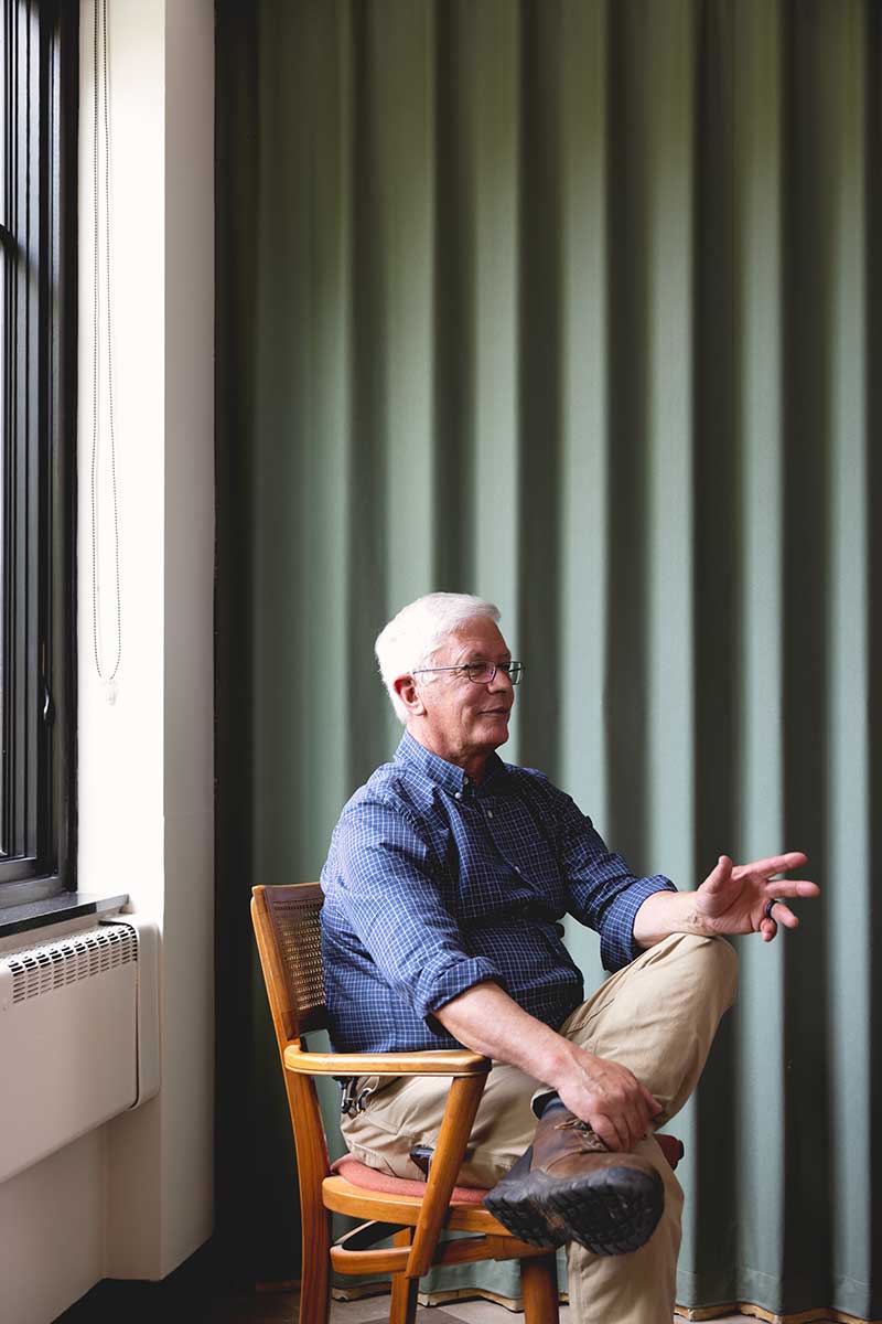 Dave Aquadro, architectural project manager at Marvin, sits in a chair next to a window inside Christ Episcopal Church in Reading, PA.