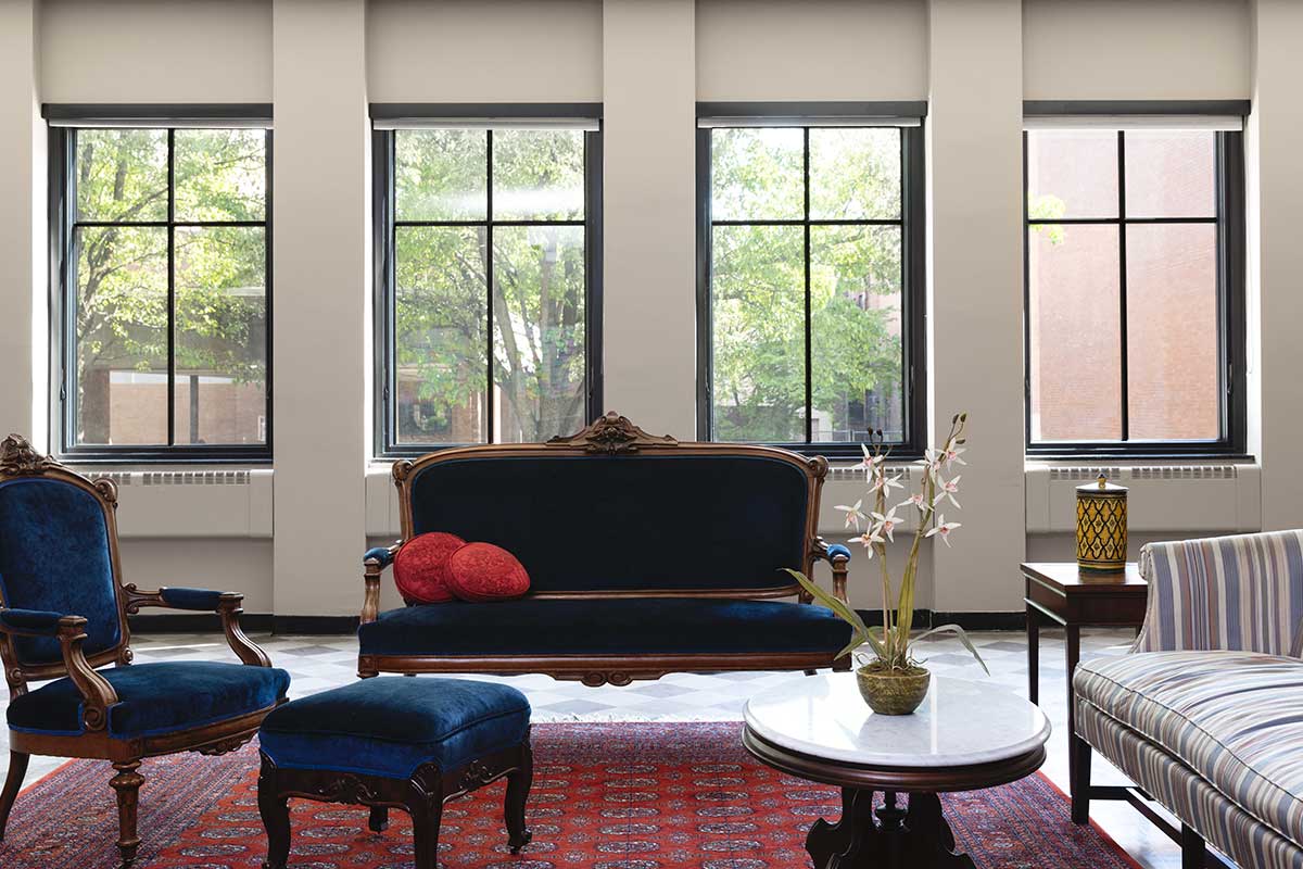 A community room inside Christ Episcopal Church in Reading, PA, featuring Marvin Ultimate windows and blue velvet furniture.