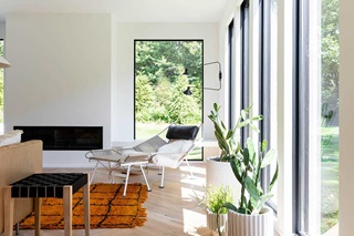 A light-filled living room with large Marvin picture windows in Kalamazoo, Michigan.