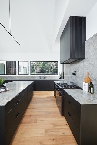 Minimalist kitchen in Hilltop Farm, a contemporary home by Hygge Custom Homes, featuring Marvin Essential windows and doors.