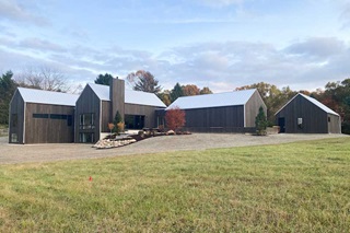 Exterior of Hilltop Farm by Hygge Custom Homes in Grand Rapids, Michigan, featuring Marvin Essential windows and doors.