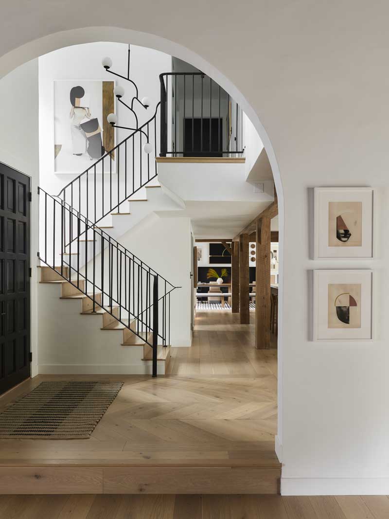 The staircase in the renovated Bobby Berk Firm’s office with modern furnishings throughout.