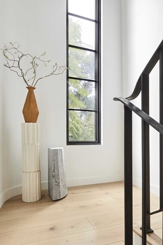 The staircase in the Bobby Berk Firm’s office, featuring a tall retangular Marvin Ultimate window to bring in lots of light to the space.