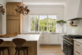 A kitchen in a coastal home, featuring Marvin Ultimate Casement Push Out windows.