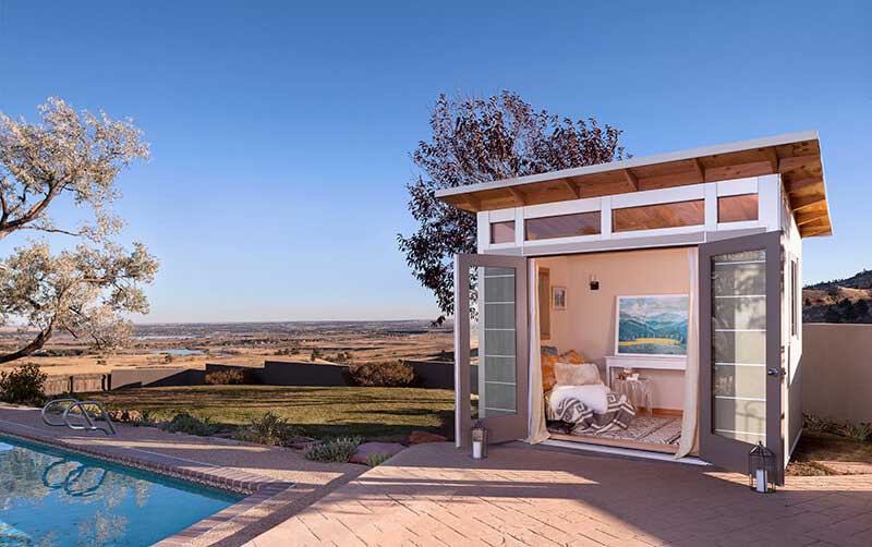 A poolside Studio Shed accessory dwelling unit.