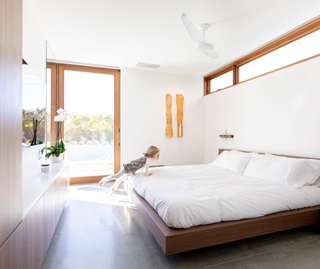 Bedroom with large wood Marvin doors and windows