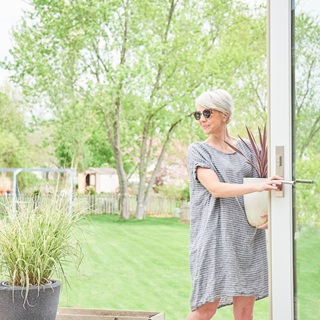 Woman Opening Door On Patio