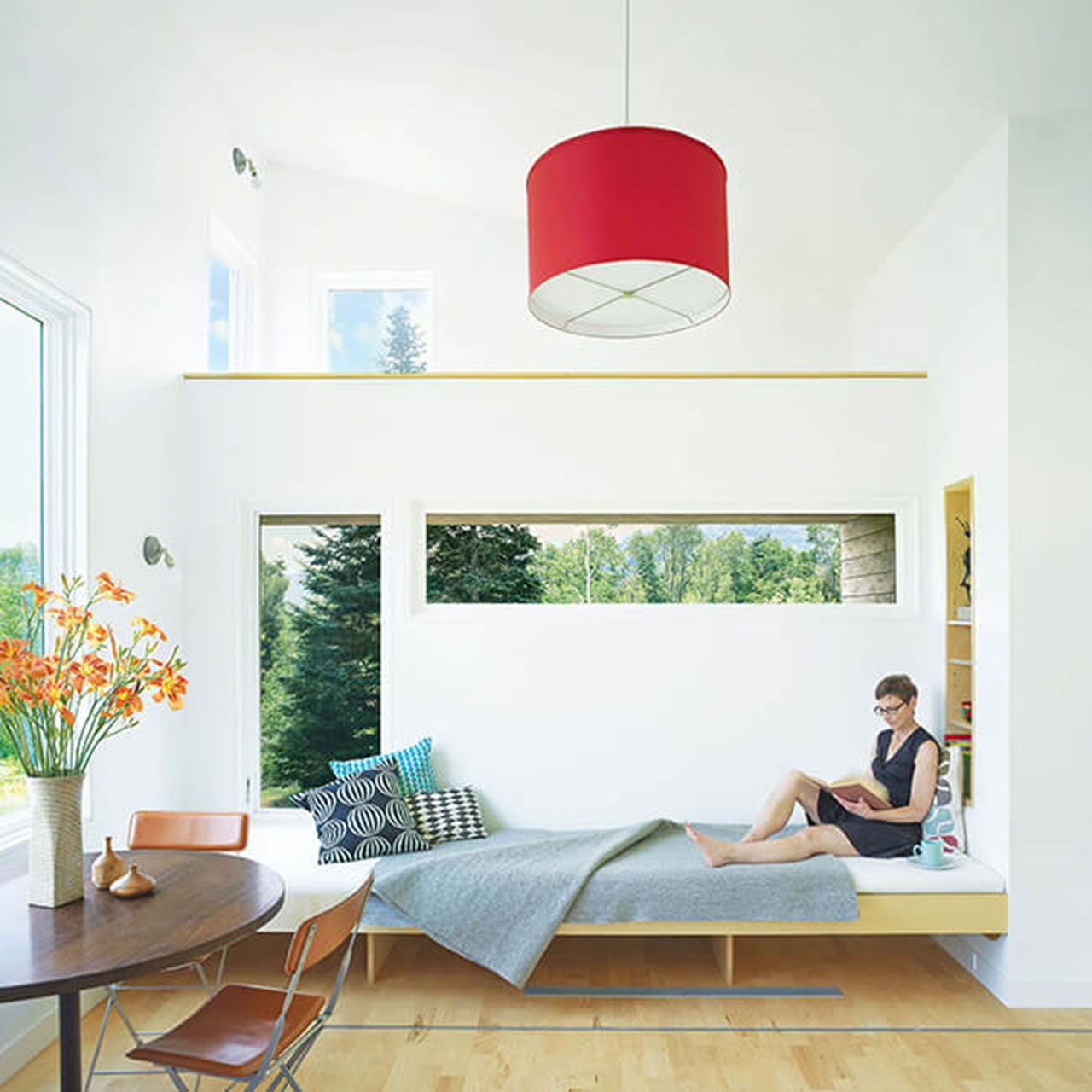 Woman Reading In Living Room With Signature Ultimate Casement Window