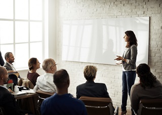 Woman presenting in front of an audience